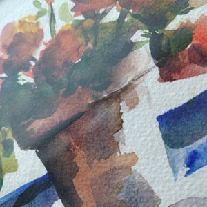 May include: Watercolour painting of a potted plant with red and orange flowers. The pot is brown and the background is white with blue watercolour strokes.