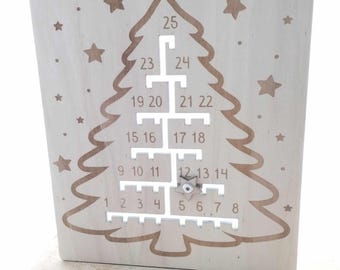 May include: A wooden Christmas tree advent calendar with 25 numbered slots. The slots are arranged in a tree shape and are numbered from 1 to 25. The calendar is made of light wood and has a natural finish.
