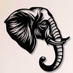 May include: Black metal wall art sculpture of an elephant's head with a detailed design. The sculpture is mounted on a white wall above a wooden shelf with books and decor.