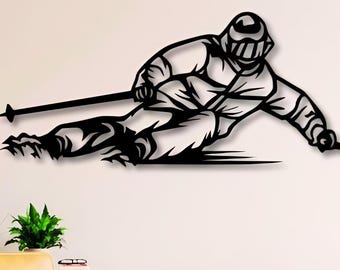 May include: Black metal wall art depicting a skier in action, carving down a slope. The artwork shows the skier in a dynamic pose, with skis and poles. This decorative piece is suitable for a living room or bedroom.