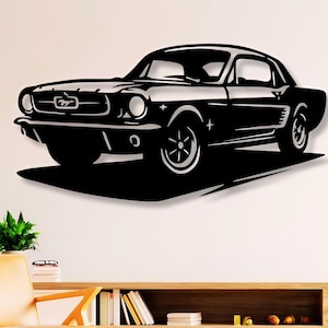 May include: Black metal wall art depicting a classic car, a vintage Ford Mustang, with a detailed silhouette of the vehicle. The car is facing the right side of the image.