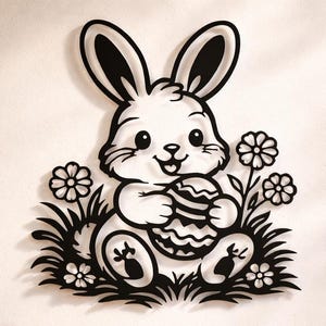 May include: Black and white Easter bunny wall art. The bunny is holding an Easter egg and is surrounded by flowers and grass. The wall art is mounted on a beige wall above a wooden cabinet.
