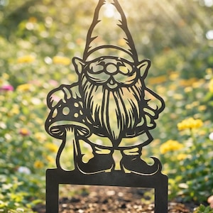 May include: A black metal garden gnome silhouette with a mushroom, set in a flower garden. The gnome has a long beard and a pointed hat. The background features colourful flowers and sunlight.