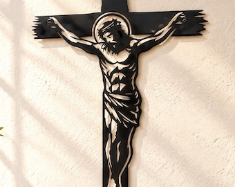 May include: A black metal wall crucifix featuring a stylized silhouette of Jesus Christ with a halo. The cross has a distressed, jagged edge design at the top and bottom. The figure is depicted with arms outstretched and a loincloth, rendered in a flat, solid black finish against the wall.