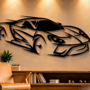 Peut inclure: Décoration murale en métal noir représentant une voiture de sport stylisée. L'œuvre est fixée sur un mur de couleur neutre, avec une console et une chaise en bois au premier plan. Le design de la voiture présente des lignes nettes et une esthétique moderne.