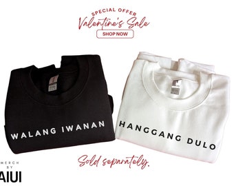 May include: Two black and white sweatshirts with text in black. The black sweatshirt says "WALANG IWANAN" and the white sweatshirt says "HANGGANG DULO". The text is centred on the sweatshirts. The sweatshirts are folded and laid out on a white background. The text "Sold separately." is written in red cursive below the sweatshirts.
