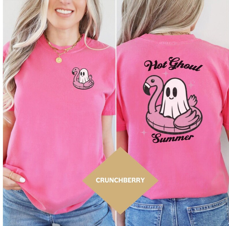 May include: A vibrant pink t-shirt with a cartoon ghost in a flamingo floatie design. The back of the shirt displays the text "Hot Ghoul Summer" above the same graphic. The tee is a solid colour and has short sleeves.