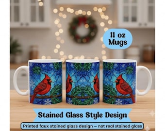 May include: Three white ceramic mugs featuring a printed faux stained glass design of a red cardinal bird perched on a pine branch against a blue snowflake background. The mugs are labeled 11 oz Mugs and Stained Glass Style Design.