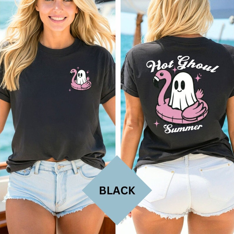 May include: Black t-shirt with a cartoon ghost on a pink flamingo floatie. The front has the graphic on the left chest. The back of the shirt has the text "Hot Ghoul Summer" with the same graphic. A summer-themed design.