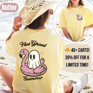 May include: A pale yellow t-shirt featuring a cartoon ghost in a pink inflatable flamingo. The back of the shirt reads "Hot Ghoul Summer". A smaller ghost graphic is on the front. The image also includes text that says "40+ CARTS! 30% OFF FOR A LIMITED TIME!"