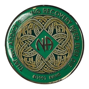 May include: Green and gold metal coin with the text "That No Addict Seeking Recovery Need Ever Die" and the NA logo in the center. The coin also has the text "©1991 NAWS".