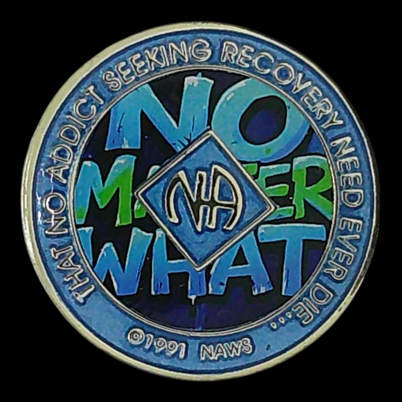 A blue recovery medallion featuring the text NO MATTER WHAT and the NA symbol.