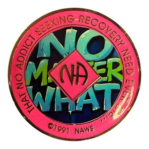A pink recovery medallion featuring the text NO MATTER WHAT and the NA symbol.