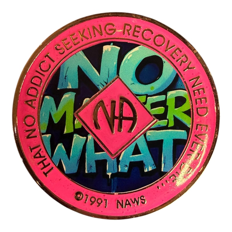 A pink recovery medallion featuring the text NO MATTER WHAT and the NA symbol.