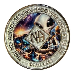 May include: A silver-colored coin with an alien in a spaceship cockpit. The alien holds a silver emblem with "NA" on it. The coin has the text "THAT NO ADDICT SEEKING RECOVERY NEED EVER DIE" and "©1991 NAWS".