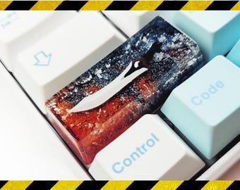 May include: A custom keyboard keycap with a blue, black, and red abstract design. The keycap features a silver knife-shaped design and the word "Control" is printed on the keycap below it.