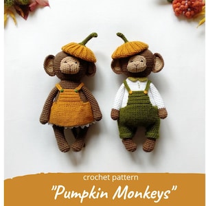 May include: Two crocheted monkey toys wearing pumpkin hats and overalls. The monkey on the left is wearing a yellow and orange outfit, while the monkey on the right is wearing a green outfit. The crochet pattern is titled "Pumpkin Monkeys".