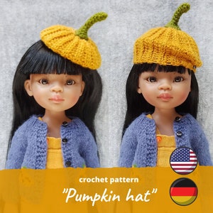 May include: Two dolls wearing crocheted pumpkin hats. The hats are yellow with green stems. The dolls have black hair and brown eyes. The dolls are wearing blue sweaters and yellow dresses. The image includes the text "crochet pattern" and "Pumpkin hat" in a yellow banner.