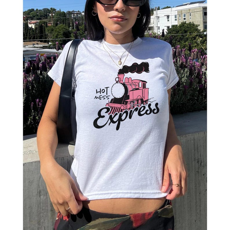 May include: White t-shirt with a pink and black cartoon train graphic and the text "Hot Mess Express".