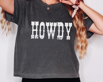 May include: A dark gray cropped t-shirt with the word "HOWDY" printed in white on the front. The shirt has a distressed look.