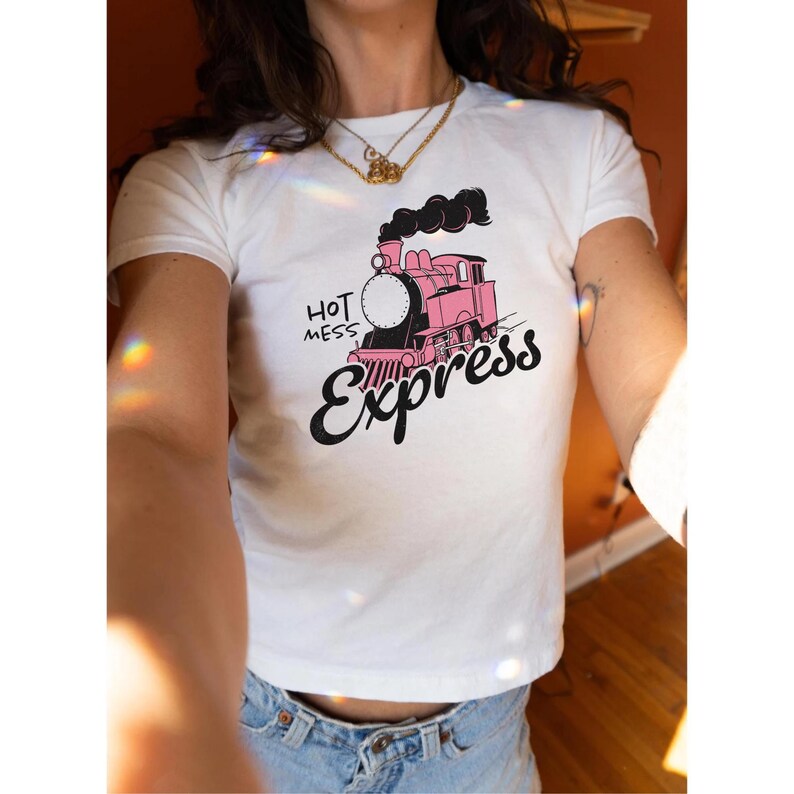 May include: White t-shirt with a pink cartoon train and the text "Hot Mess Express" printed on the front.