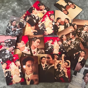 May include: A selection of rectangular photo cards displaying images of people in formal wear. The cards show various scenes, including portraits and group shots, with a red and white colour scheme. Some cards show people with cake.