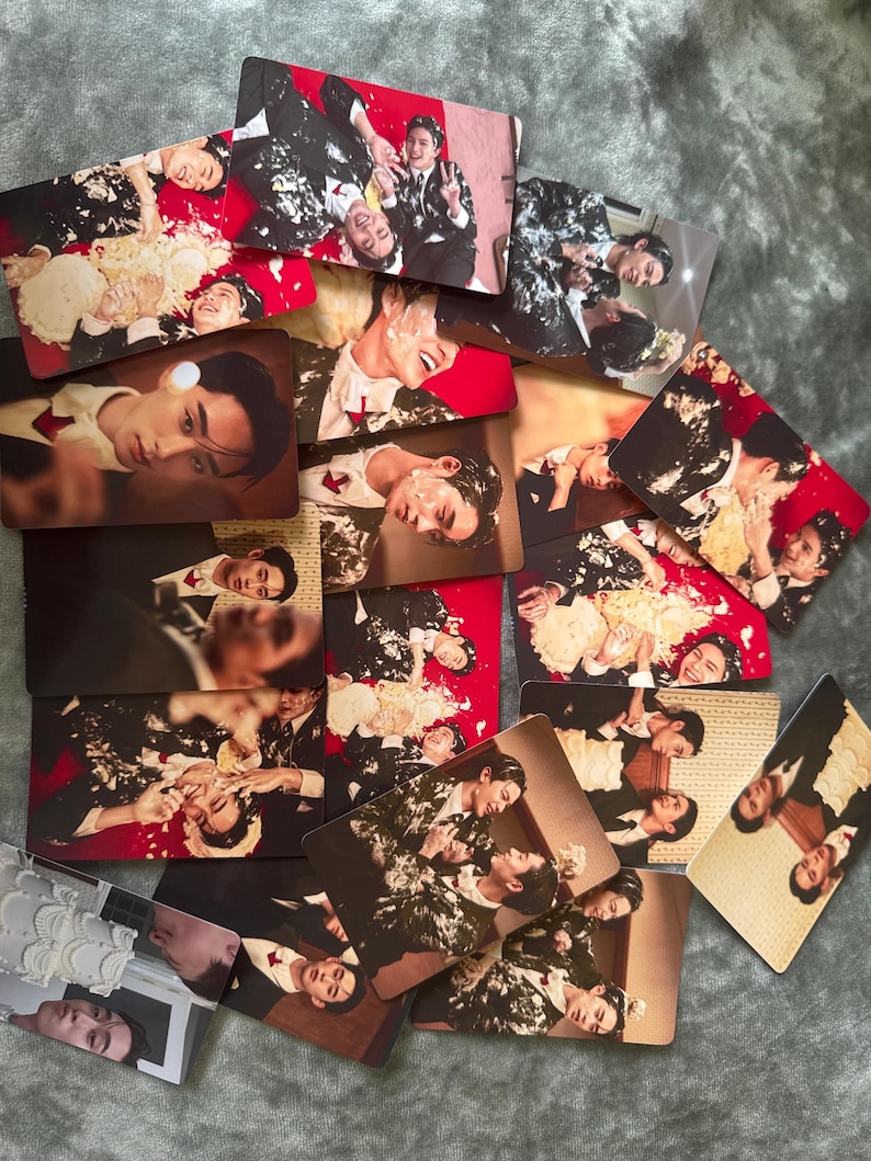 May include: A collection of rectangular photo cards featuring images of people in suits, some with cake on their faces. The cards have a red or brown background. The images show various poses and expressions.