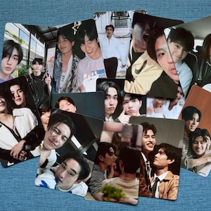 May include: A collection of rectangular photo cards featuring various young men in different poses and settings. The cards are arranged in a fan-like pattern, with a blue background.