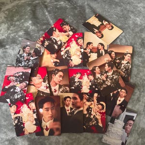 May include: A collection of rectangular photo cards featuring images of people in formal attire. The cards display various scenes, including portraits and group shots, with some cards showing cake and red backgrounds.