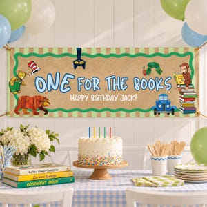 May include: A rectangular birthday banner with a tan background and green scalloped border, featuring the text ONE FOR THE BOOKS HAPPY BIRTHDAY JACK! and illustrations of a bear, a caterpillar, a monkey, and a blue truck.
