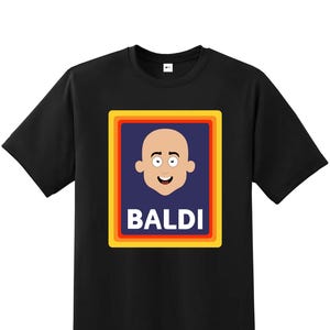 May include: Black t-shirt with a graphic of a bald head with a smiling face inside a blue rectangle with yellow and orange borders. The word "BALDI" is printed in white letters below the face.