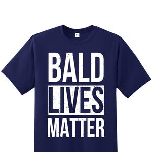 May include: A navy blue t-shirt with the text "BALD LIVES MATTER" in white distressed lettering.