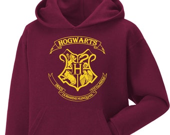 Sudadera con capucha de Hogwarts de Daily Apparel para niños y adultos: sudadera con capucha con el escudo y la varita mágicas del colegio.