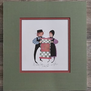May include: A vintage illustration of two people in traditional clothing holding a red and white checkered bag with the text "Purina Dog Chow" printed on it. The illustration is signed by the artist, "Barnaby A.  of  "It takes two"