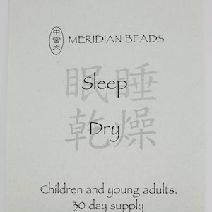 May include: A white package with black text that reads "MERIDIAN BEADS" and "Sleep Dry". The package also includes Chinese characters and the text "Children and young adults. 30 day supply."