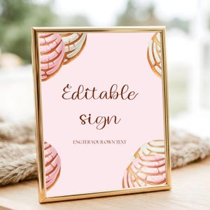 May include: A framed sign with a gold border and a light pink background. The sign features watercolor illustrations of conchas in each corner. The text "Editable sign" is written in a brown script font, with the words "Enter your own text" below.