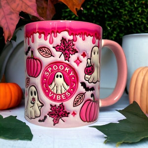 Pink coffee mug with ghosts, pumpkins and other Halloween motifs