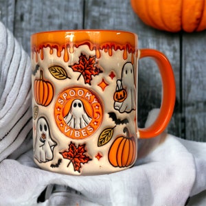 Orange coffee cup with ghosts, pumpkins and other Halloween motifs, 3D look