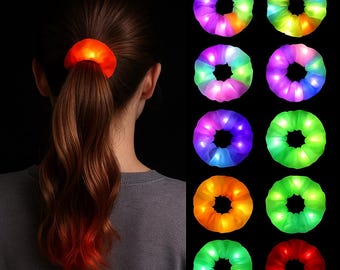 May include: A person's ponytail secured with a glowing orange scrunchie. To the right, several illuminated scrunchies in various colors: purple, green, yellow, and red. The scrunchies appear to have small LED lights.