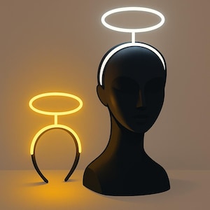 May include: A black mannequin head with a white halo headband and a separate yellow halo headband. The halo headbands are illuminated with neon lights. The background is a neutral color.