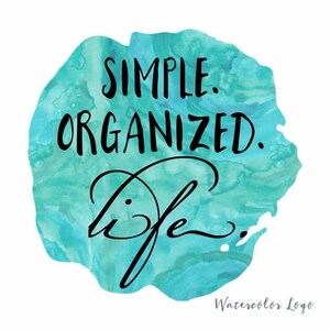 May include: Watercolor design with the text "Simple. Organized. life." in black lettering on a turquoise blue background.