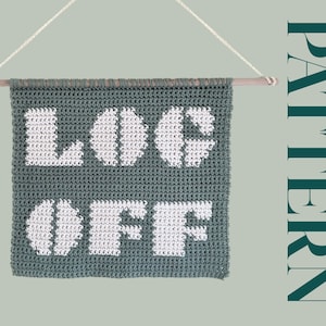 May include: A teal crochet wall hanging with the words "LOG OFF" in white yarn.