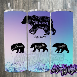 May include: Three stainless steel tumblers with a gradient design of purple, pink, and blue. The tumblers feature black bear silhouettes with the words "Mama Est. 2004" on the middle tumbler and the names "Emerie", "Paighton", and "Arielle" on the other tumblers.