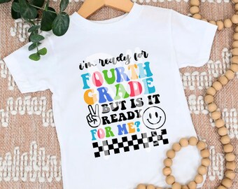May include: White t-shirt with a colorful graphic that says "I'm ready for fourth grade but is it ready for me?" with a peace sign and a smiley face.