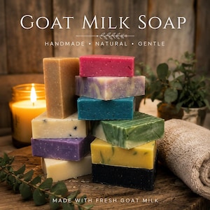 May include: A stack of rectangular goat milk soap bars in various colors including pink, purple, blue, green, yellow, black, and cream. The text GOAT MILK SOAP, HANDMADE, NATURAL, GENTLE, and MADE WITH FRESH GOAT MILK is visible in the image.