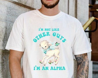May include: White t-shirt with a blue and white graphic of a lamb with a butterfly and the text "I'm not like other guys I'm an alpha".