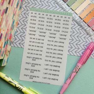 May include: A white card with a green header that reads "COMEDIC COMMITTEE" and a list of phrases in black text. The phrases include "HA REAL", "I'M DEAD", "cackling", "not one lie was told", "they're carrying this book", and "I can't stop laughing".