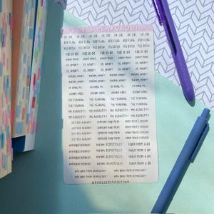 May include: A rectangular sticker sheet titled PLOT'S PLAYGROUND featuring multiple rows of small, black text phrases including RED FLAG, YES BITCH, RIDE OR DIE, POWER MOVE, VILLAIN VIBES, THE YEARNING, THE AUDACITY, and UNHINGED BEHAVIOR on a white background.
