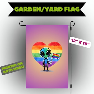 May include: A garden flag with a cartoon alien holding a rainbow flag, set against a rainbow heart. The flag measures 30.48 cm x 45.72 cm and is printed on both sides. The text "GARDEN/YARD FLAG" is at the top.