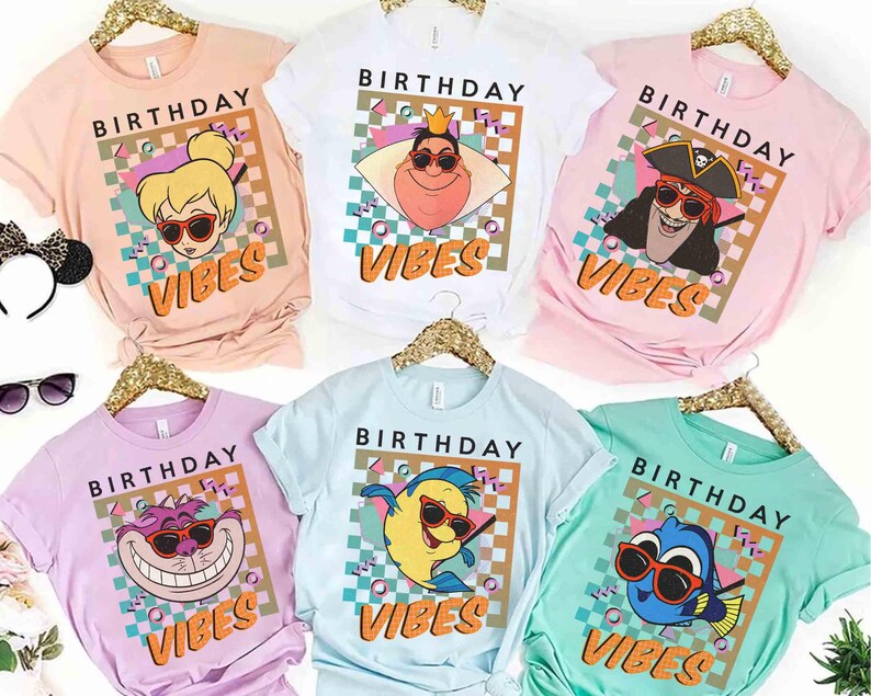 May include: Six t-shirts in various pastel colours, each with a cartoon character wearing sunglasses and the words "BIRTHDAY VIBES". The shirts are in pink, white, lilac, light blue, and mint green, perfect for a birthday celebration.